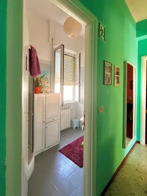a room with green walls and a green hallway at 4321 B&B Stazione Trastevere in Rome