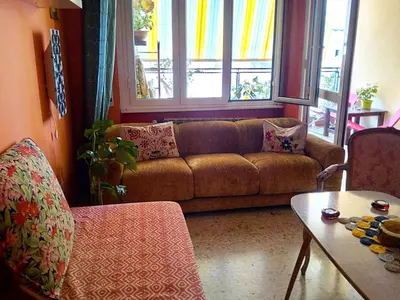 a living room with a couch and a table at 4321 B&B Stazione Trastevere in Rome