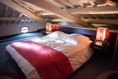 a large bed in a room with two lamps at Archdesign Studio in Rome
