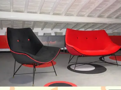 two red and black chairs sitting in a room at Archdesign Studio in Rome