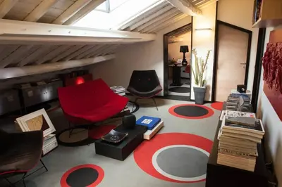 a living room with two chairs and a red couch at Archdesign Studio in Rome