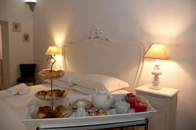 a bed with a tray of food on a table at B&B La finestra sul Colosseo in Rome