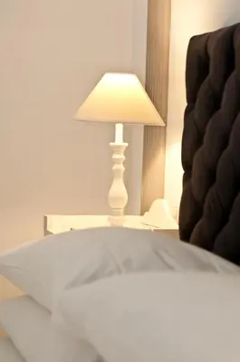 a lamp sitting on a table next to a bed at B&B La finestra sul Colosseo in Rome
