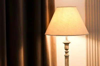 a lamp sitting next to a curtain in a room at B&B La finestra sul Colosseo in Rome