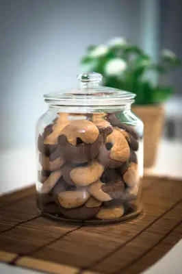 a glass jar filled with cookies sitting on a table at Laura Family Apartments in Rome