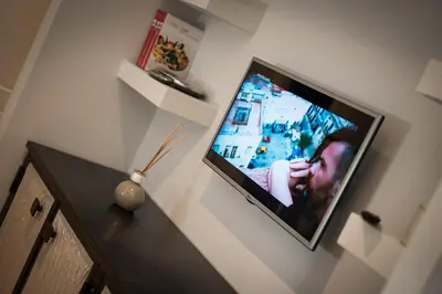a flat screen tv hanging on a wall at Laura Family Apartments in Rome