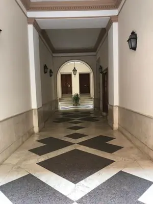 an empty hallway with a tile floor in a building at Laura Family Apartments in Rome