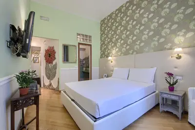 a bedroom with a large white bed in a room at Gli Artisti Apartments Rome in Rome