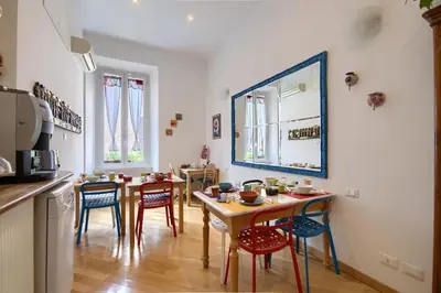 a kitchen with a table and chairs in a room at Gli Artisti Apartments Rome in Rome