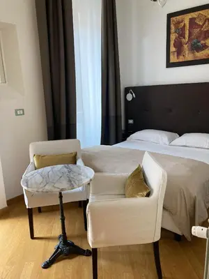 a bedroom with a bed and a chair and a bed at Gli Artisti Apartments Rome in Rome