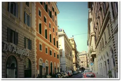 a city street with buildings and cars parked on the street at Hotel Louisiana in Rome
