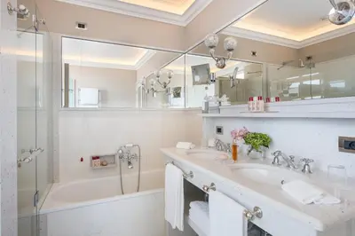 a bathroom with a tub and a sink and a shower at Hassler Roma in Rome