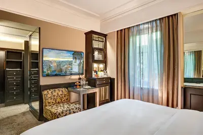 a hotel room with a bed and a chair at Hassler Roma in Rome