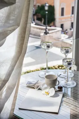 a table with glasses and a coffee cup on it at Il Palazzetto in Rome