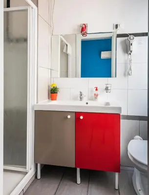 a bathroom with a red cabinet and a sink at Ai Musei Vaticani BB in Rome
