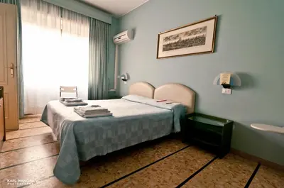 a bedroom with a bed in a room with a window at Ai Musei Vaticani BB in Rome