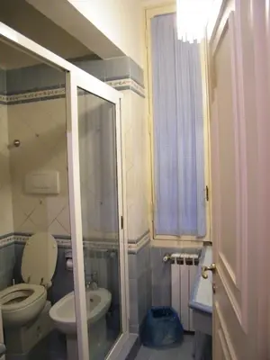a small bathroom with a toilet and a shower at Vacanze Romane in Rome