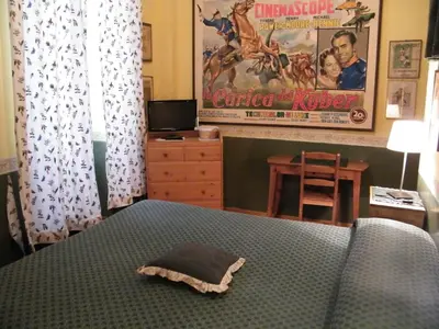 a bedroom with a bed with a comforter on it at Vacanze Romane in Rome