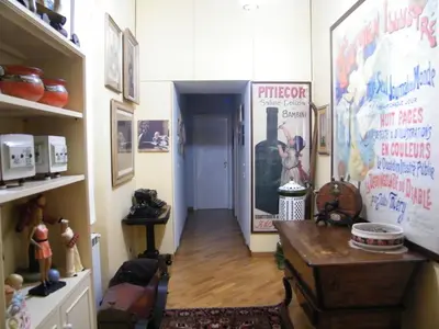 a hallway of a room with a room with a table and a door at Vacanze Romane in Rome