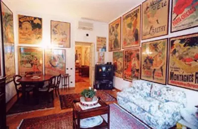 a living room with a lot of posters on the wall at Vacanze Romane in Rome