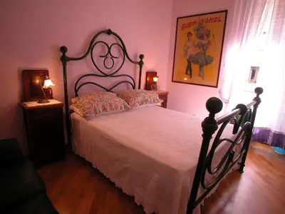 a bedroom with a large bed with a white bedspread at Vacanze Romane in Rome