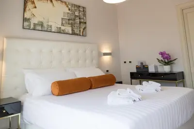 a bedroom with a white bed with two slippers on it at Zaccardi Roof Garden in Rome