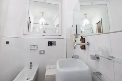 a white bathroom with a sink and a toilet at Zaccardi Roof Garden in Rome
