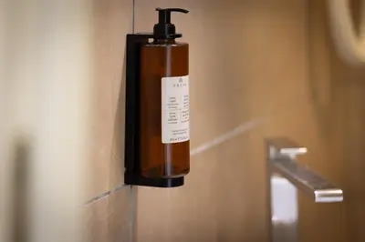 a bottle of soap is attached to a wall at Zaccardi Roof Garden in Rome