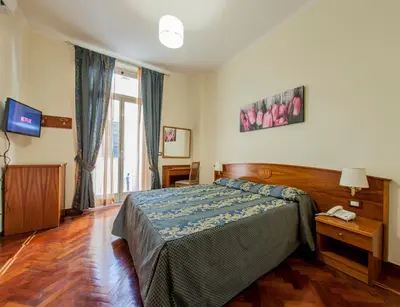 a bedroom with a bed and a television in it at Hotel Domus Praetoria in Rome