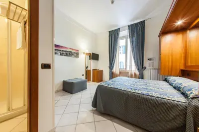 a bedroom with a bed and a window at Hotel Domus Praetoria in Rome