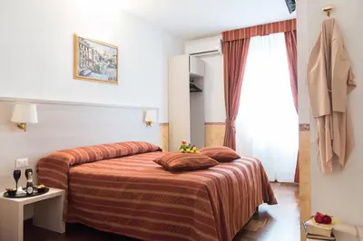 a hotel room with a bed and a window at Domus Giulia in Rome