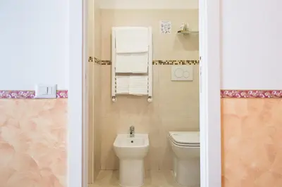 a bathroom with a toilet and a sink at Domus Giulia in Rome