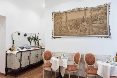 a dining room with two tables and a painting on the wall at Domus Giulia in Rome