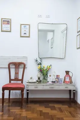 a desk with a chair and a mirror on a wall at Domus Giulia in Rome