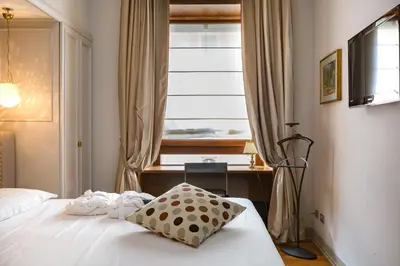 a bedroom with a bed with a pillow and a window at Rooms Roma - Monti in Rome