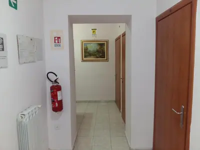 a hallway with a fire extinguisher on the wall at Sun Moon in Rome