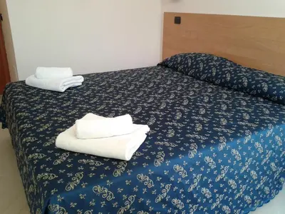 two towels on a bed in a hotel room at Sun Moon in Rome