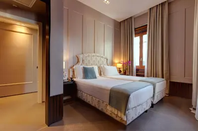 a bedroom with a large bed and a window at Singer Palace Hotel Roma in Rome