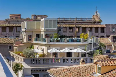 a view of a building with a balcony with umbrellas at Singer Palace Hotel Roma in Rome
