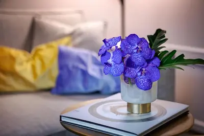 a vase of purple flowers sitting on a table at Singer Palace Hotel Roma in Rome
