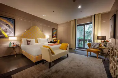 a bedroom with a king sized bed and a chair at Singer Palace Hotel Roma in Rome