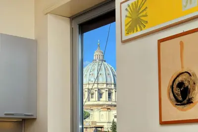 a view of a building through a window at Saint Peter's Bright Apartment | Romeloft in Rome