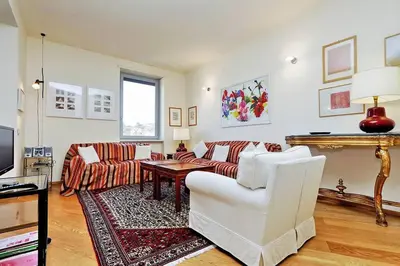 a living room with a couch and a table at Saint Peter's Bright Apartment | Romeloft in Rome