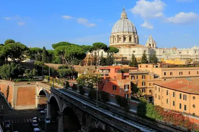 a view of a city with a bridge and a cathedral at Saint Peter's Bright Apartment | Romeloft in Rome