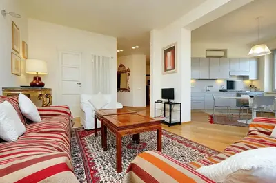 a living room with two couches and a table at Saint Peter's Bright Apartment | Romeloft in Rome