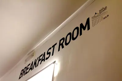 a sign on a wall with the name of a room at San Peter Rome B&B in Rome