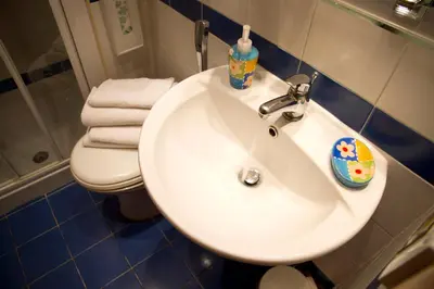 a bathroom with a white sink and a toilet at San Peter Rome B&B in Rome