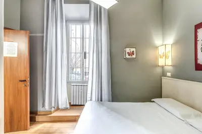 a bedroom with a bed and a window at Guest House Trastevere in Rome
