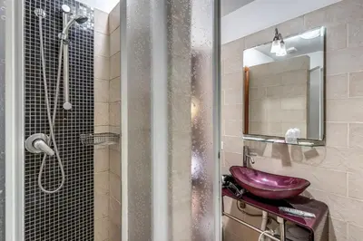 a bathroom with a purple sink and a shower at Guest House Trastevere in Rome