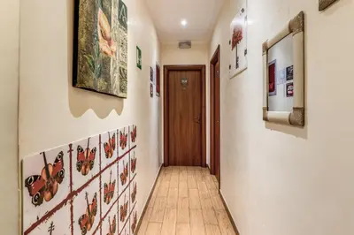 a hallway with art on the walls of a house at Guest House Trastevere in Rome